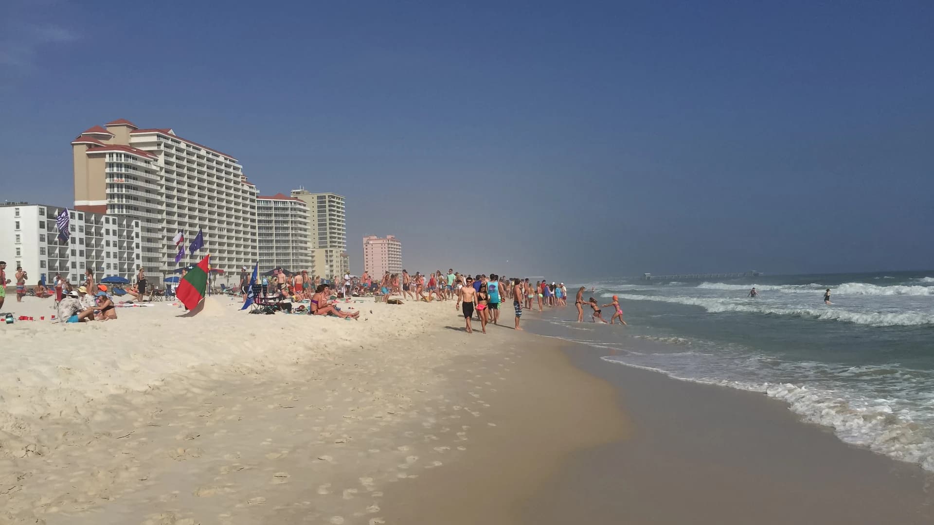 White sand, Gulf surf and beachfront towers at Gulf Shores, Alabama